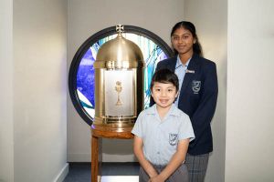 All Saints Catholic College Family and Faith - students with holy chalice