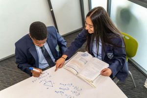 All Saints Catholic College Learning and Achievement - students resolving a maths equation