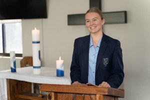 All Saints Catholic College Shared Mission - student speaking in front of mass