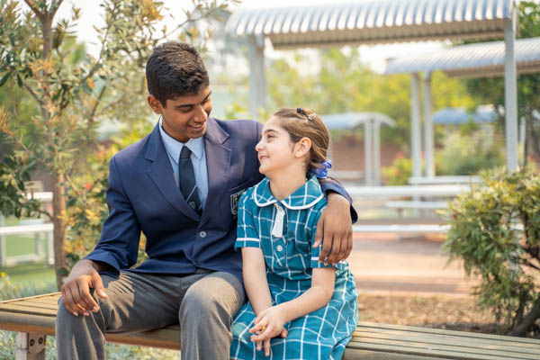 All Saints Catholic College Student Wellbeing - students sitting on bench