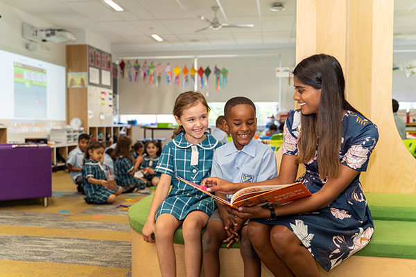 casual-teaching-at-All-Saints-Casula-Liverpool teacher reading book with students